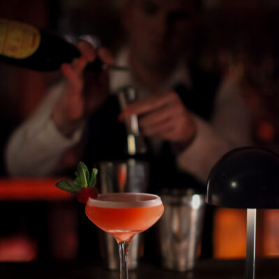 Bartender crafting cocktail in warm ambient Lime Tree Bar