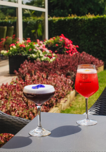 Colorful cocktails served in warm sunlit patio setting